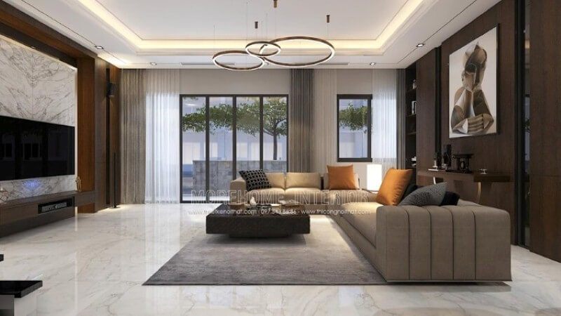 Bố trí nội thất phòng khách cao cấp ấn tượng với cách trang trí cuốn hút đối lập giữa hai mảng tường chính: bức tranh canvas trừu tượng nâu trầm tương phản với sự mạnh mẽ từ khối đá đối vân lớn.